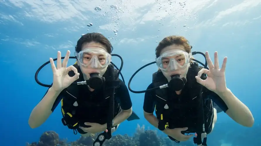 A certified scuba dive buddy guiding divers with Luma Selakan near Semporna